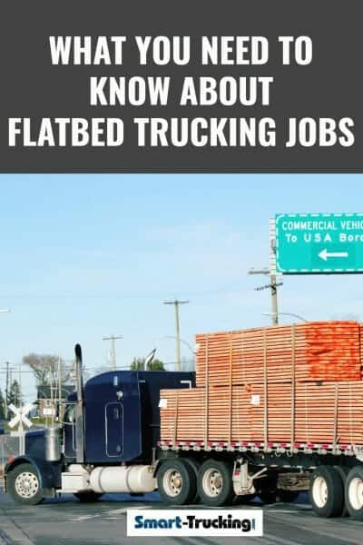 Peterbilt truck pulling a load of lumber on a flatbed trailer