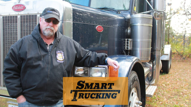 Truck driver standing beside his Peterbilt truck