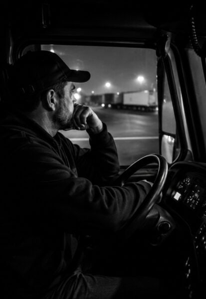 Truck Driver thinking quietly in the cab of his truck